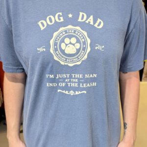 Person wearing "Dog Dad" graphic t-shirt.