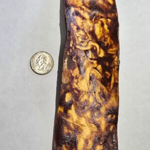 Large brown strip next to a coin.