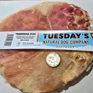 Dog treat with label and coin comparison.