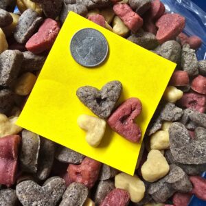 Heart-shaped dog treats with a coin.
