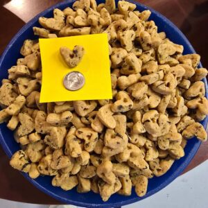Bowl of snacks with quarter and note.