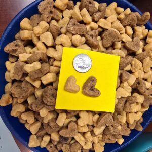 Heart-shaped cereal with a coin for scale.