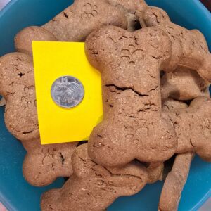 Dog bone treats beside a coin.